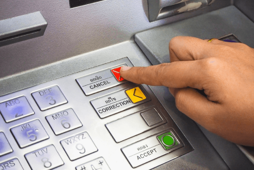 image of a man clicking ATM button