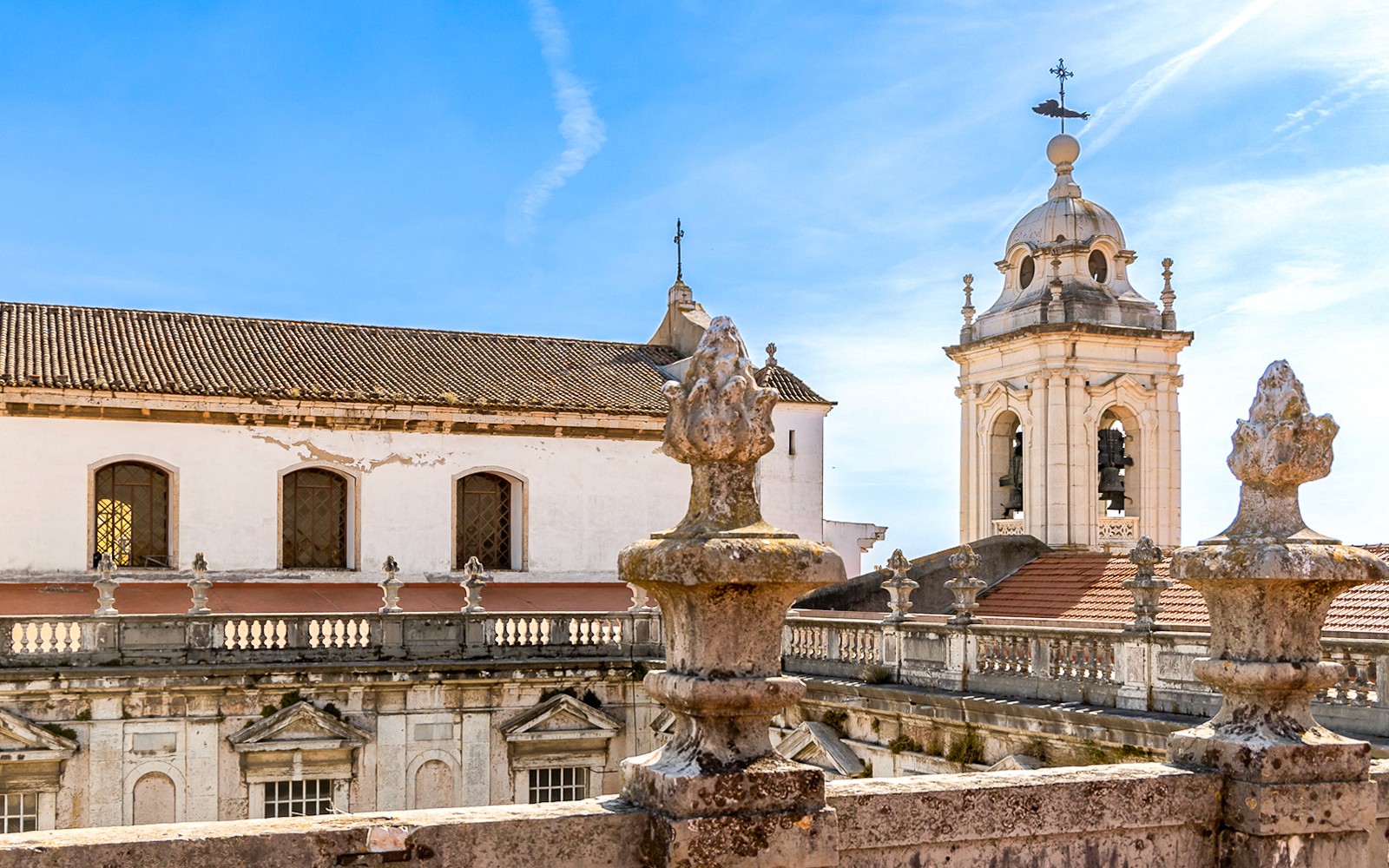 Lisbon cityscape from Church of Graça terrace viewpoint, showcasing iconic landmarks and skyline.