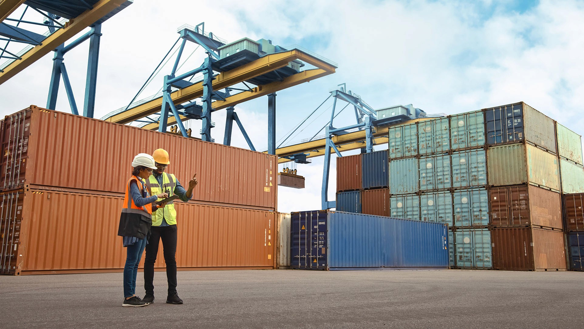 Stacked containers under loading cranes in a port