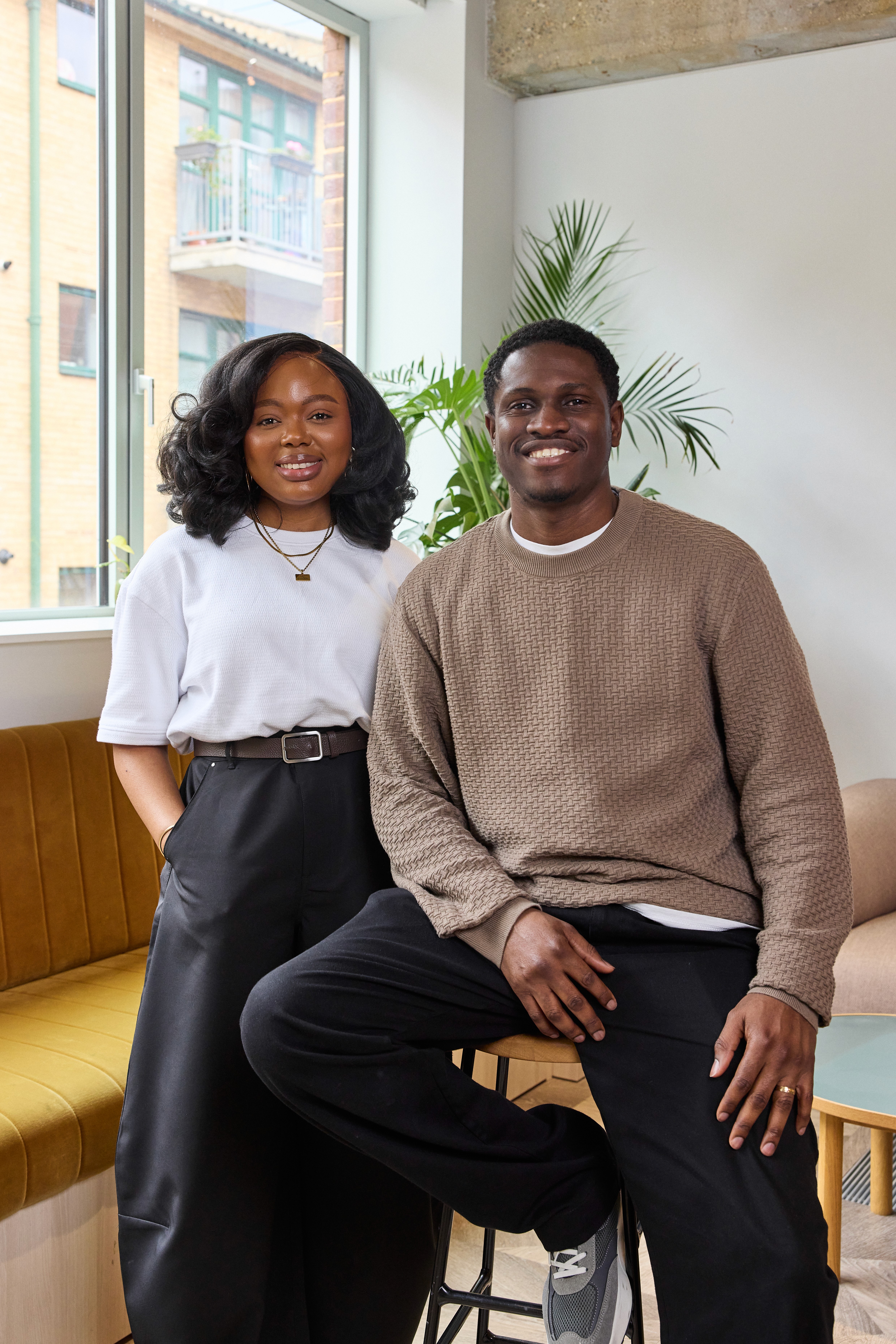 a small child laying on a bed playing with a tablet