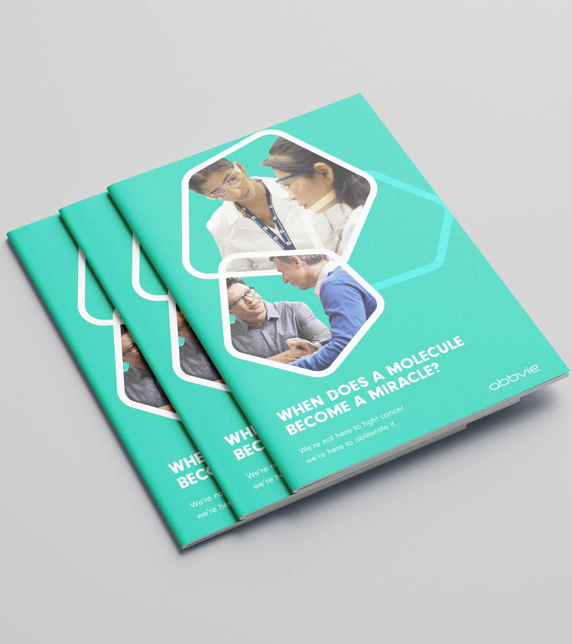 Stack of green AbbVie recruitment brochures on a grey surface