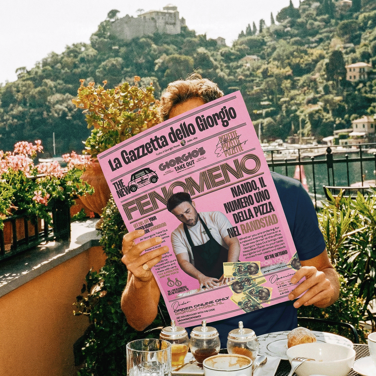 person sitting with a news paper on an italian terrace somewhere in a mediterranean setting