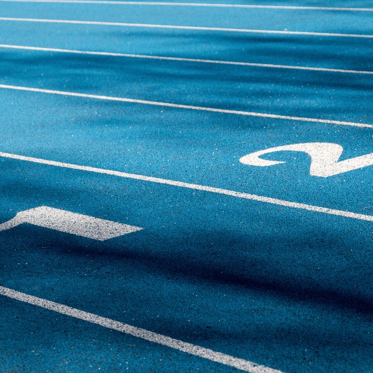 Indoor running track lanes with lane numbers painted on a synthetic track surface