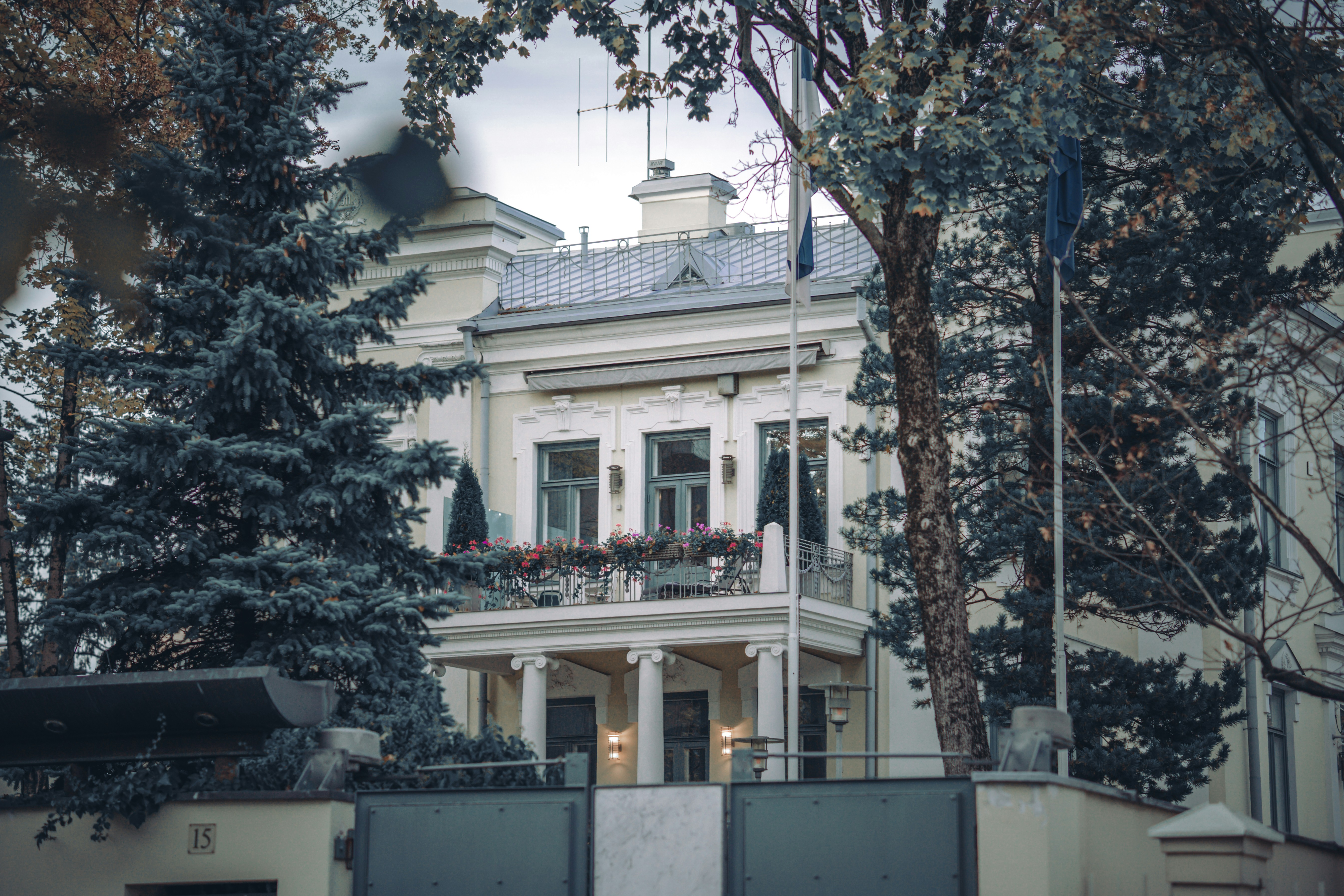 a white house with trees in the front