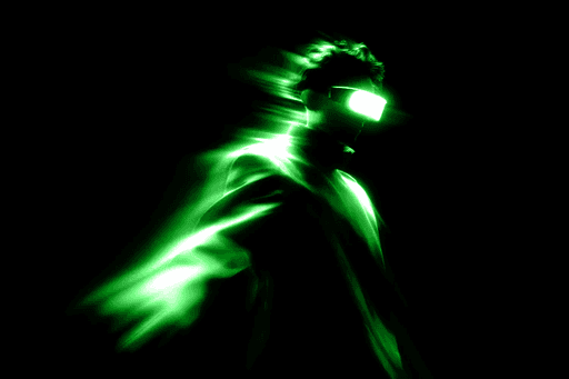 Man in virtual reality headset with green light trails