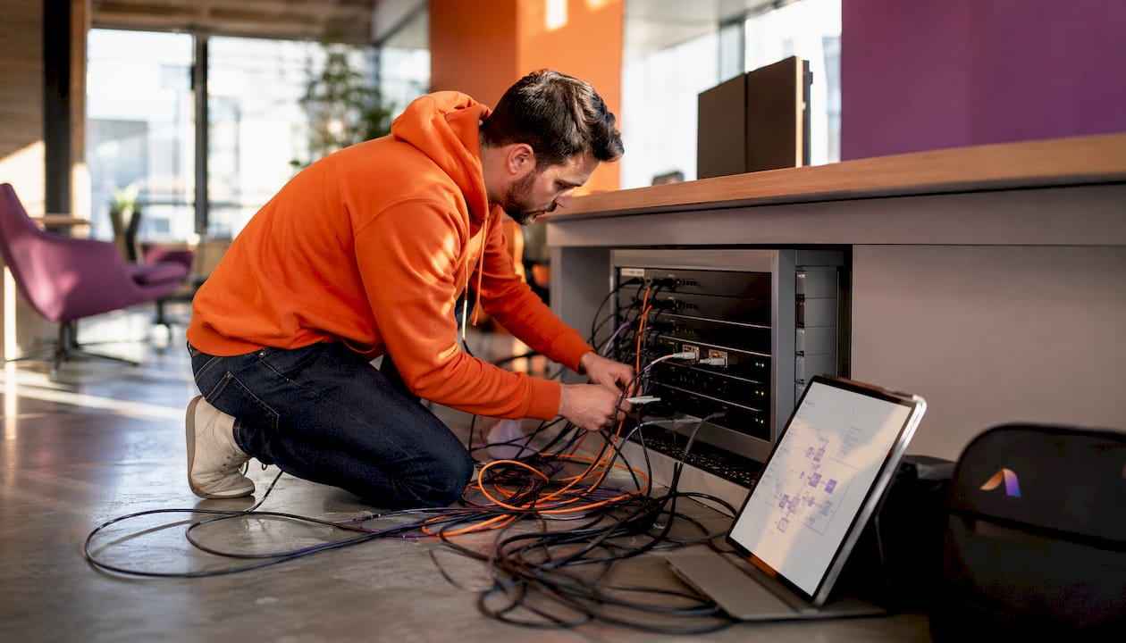 IT specialist connecting retail AI system hardware