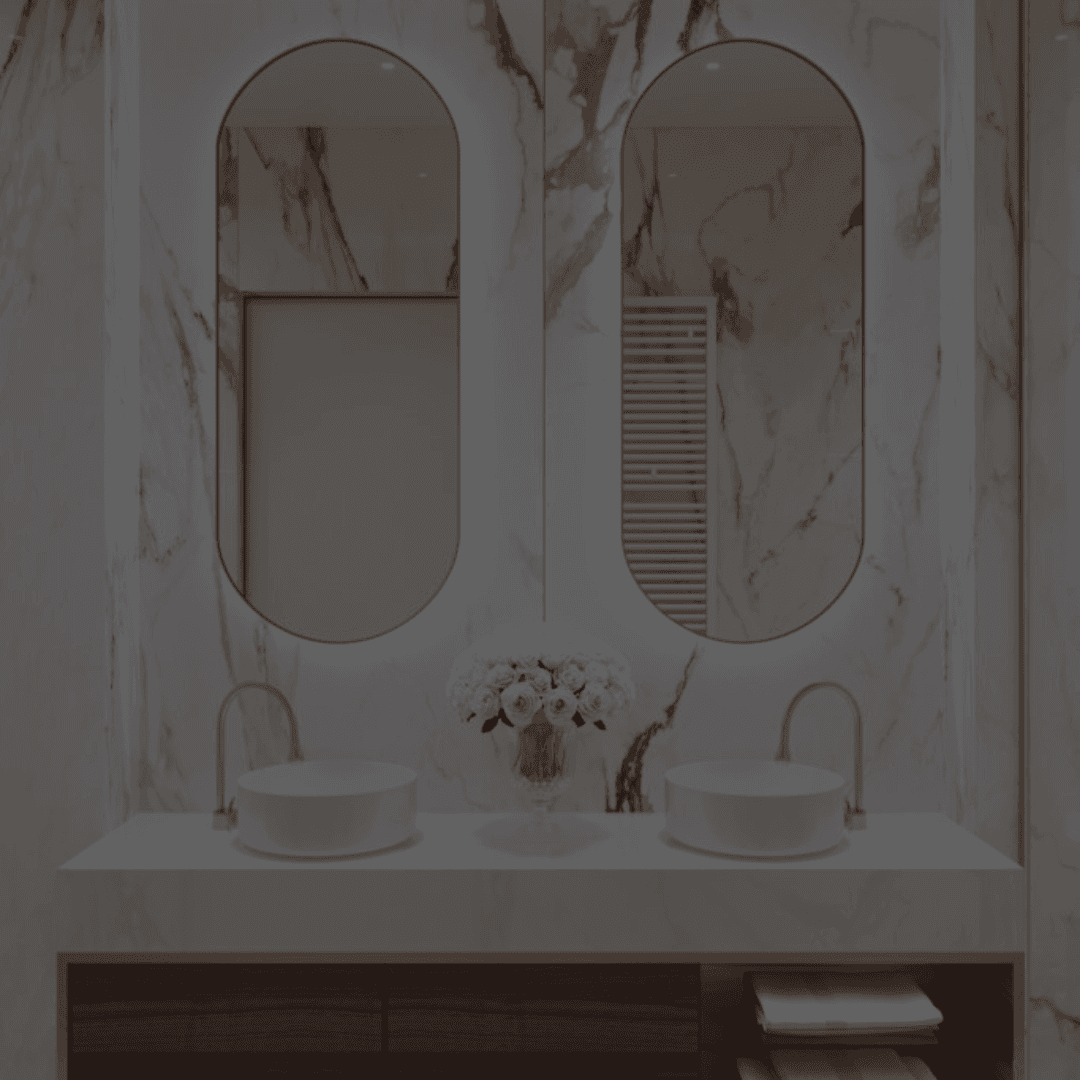 Elegant double-sink bathroom remodel with gold-accented marble walls, arched mirrors, and modern vessel sinks by B&Y Reno Corp