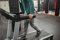 A professionally reconditioned commercial treadmill ready for use in a gym setting.