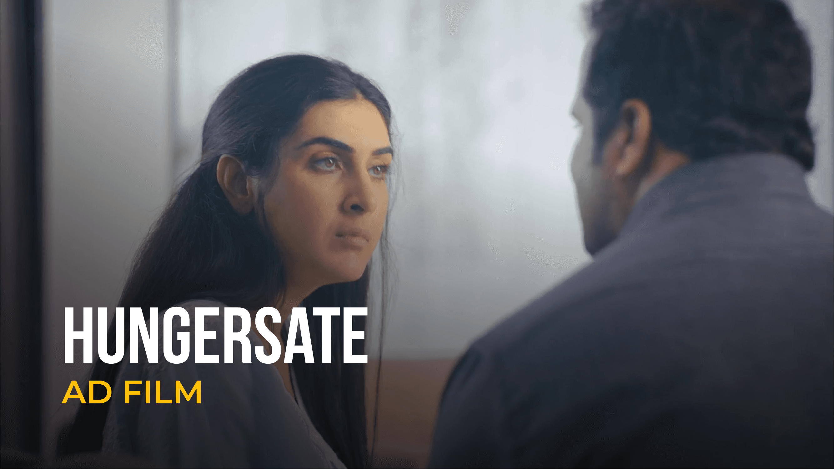 Woman looking at a man during a scene from a Hungersate ad film.