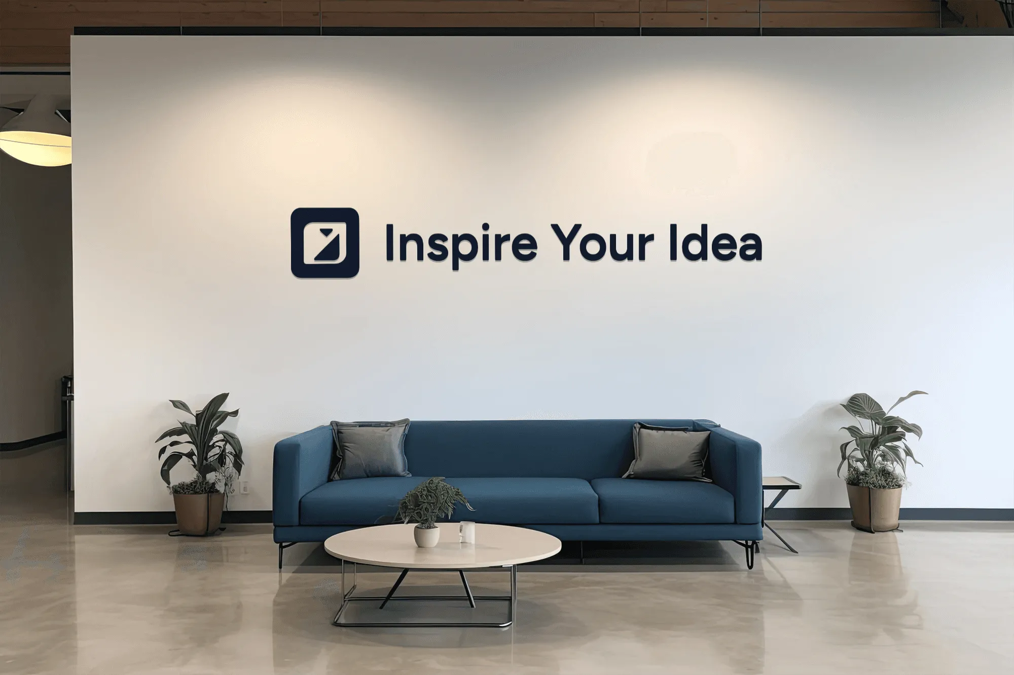 Blue sofa and coffee table in front of "Inspire Your Idea" wall art.