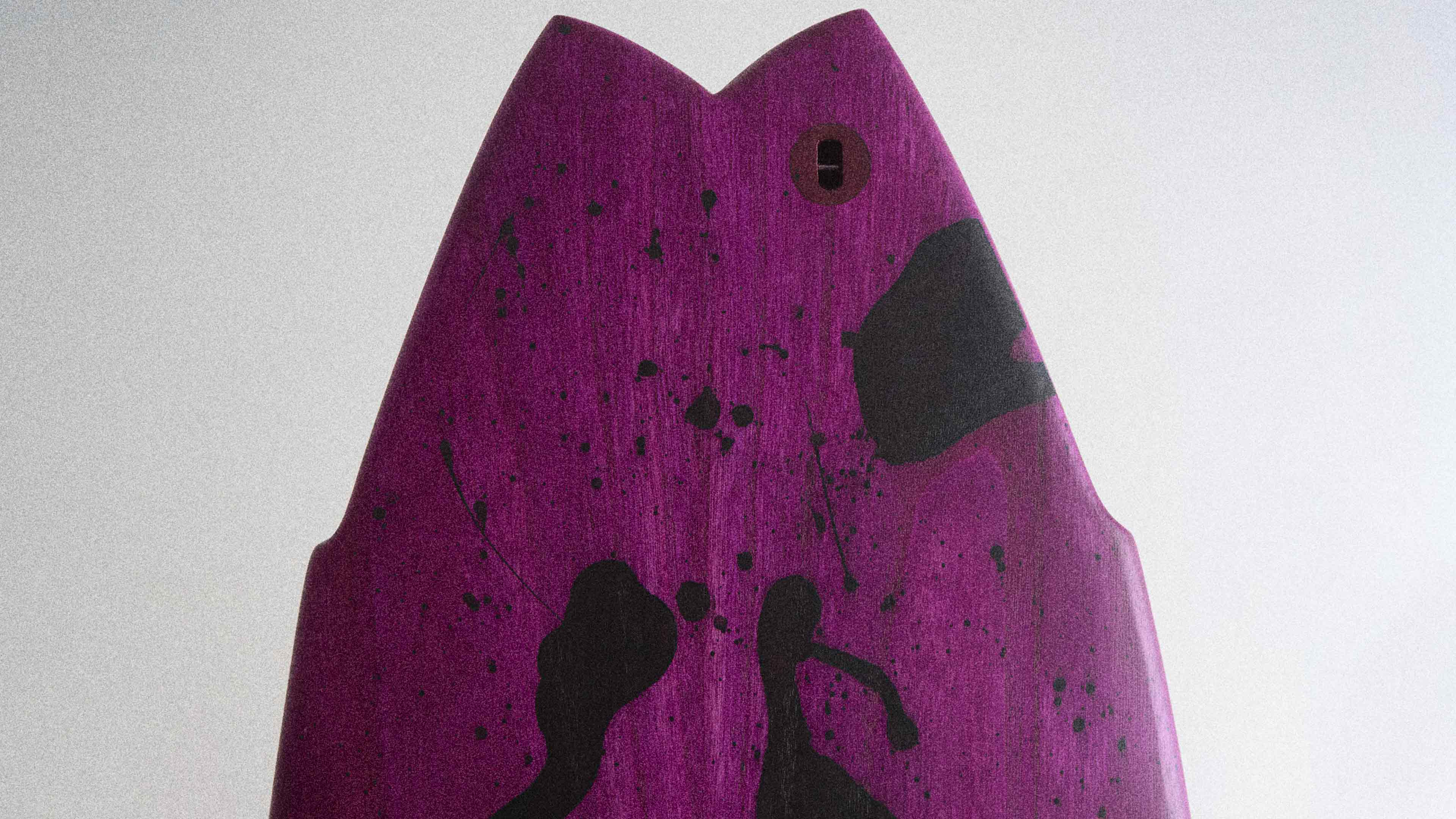 Wooden surfboard with purple and black splash artwork
