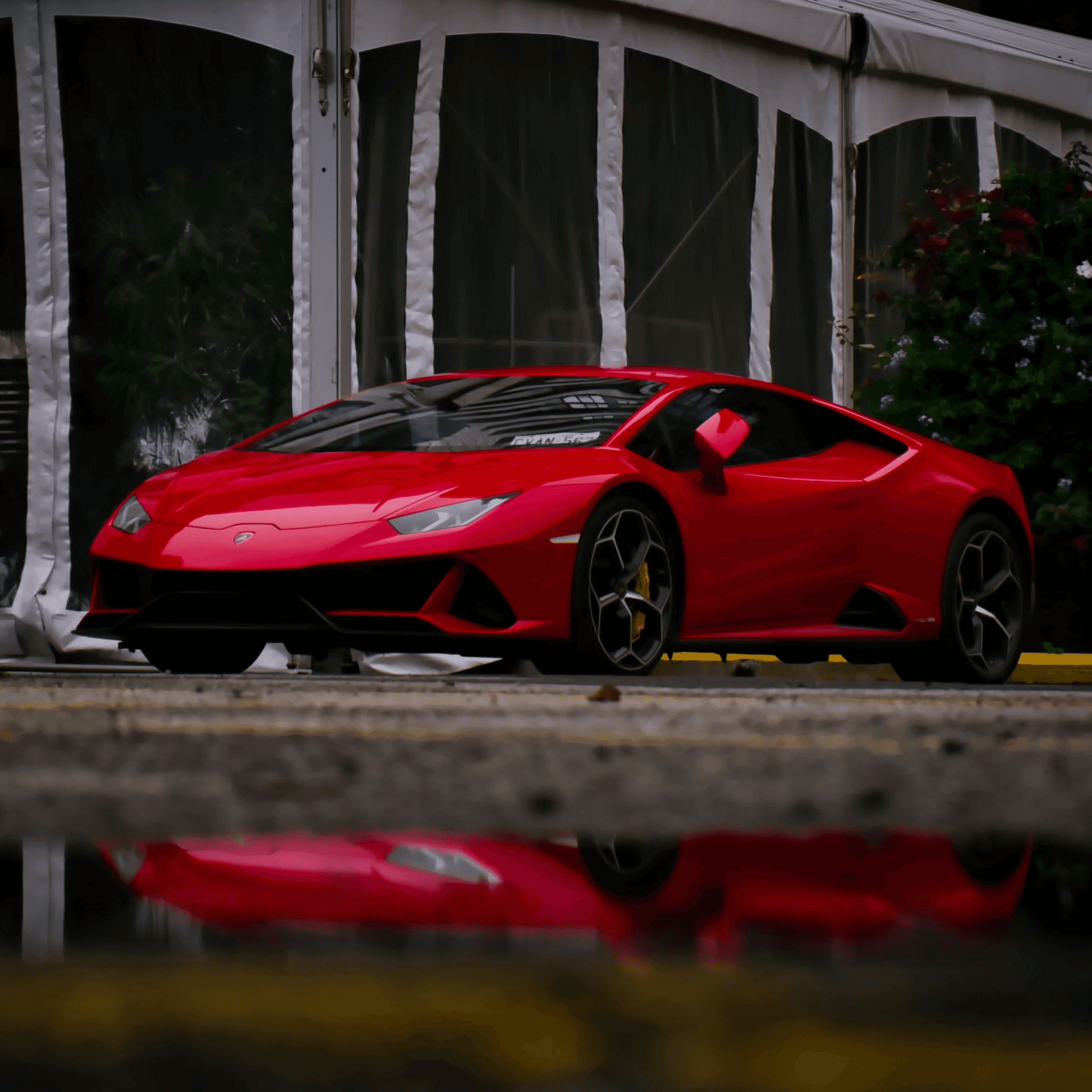 a red sports car parked in front of a building