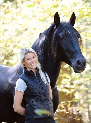 Close-up of lush, dark green leaves, some glossy and wet, against a muted background.