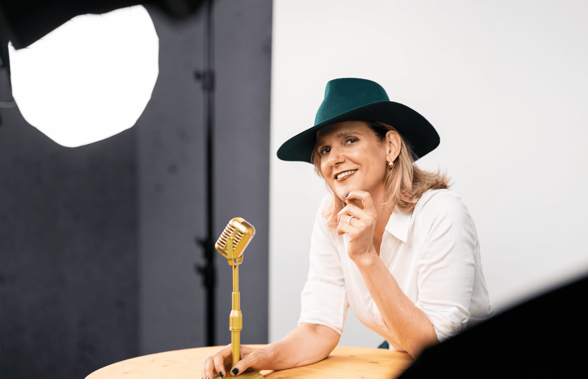 Danielle Zuber from Singers Evolution with a gold microphone during a photoshoot for the project coaching program.