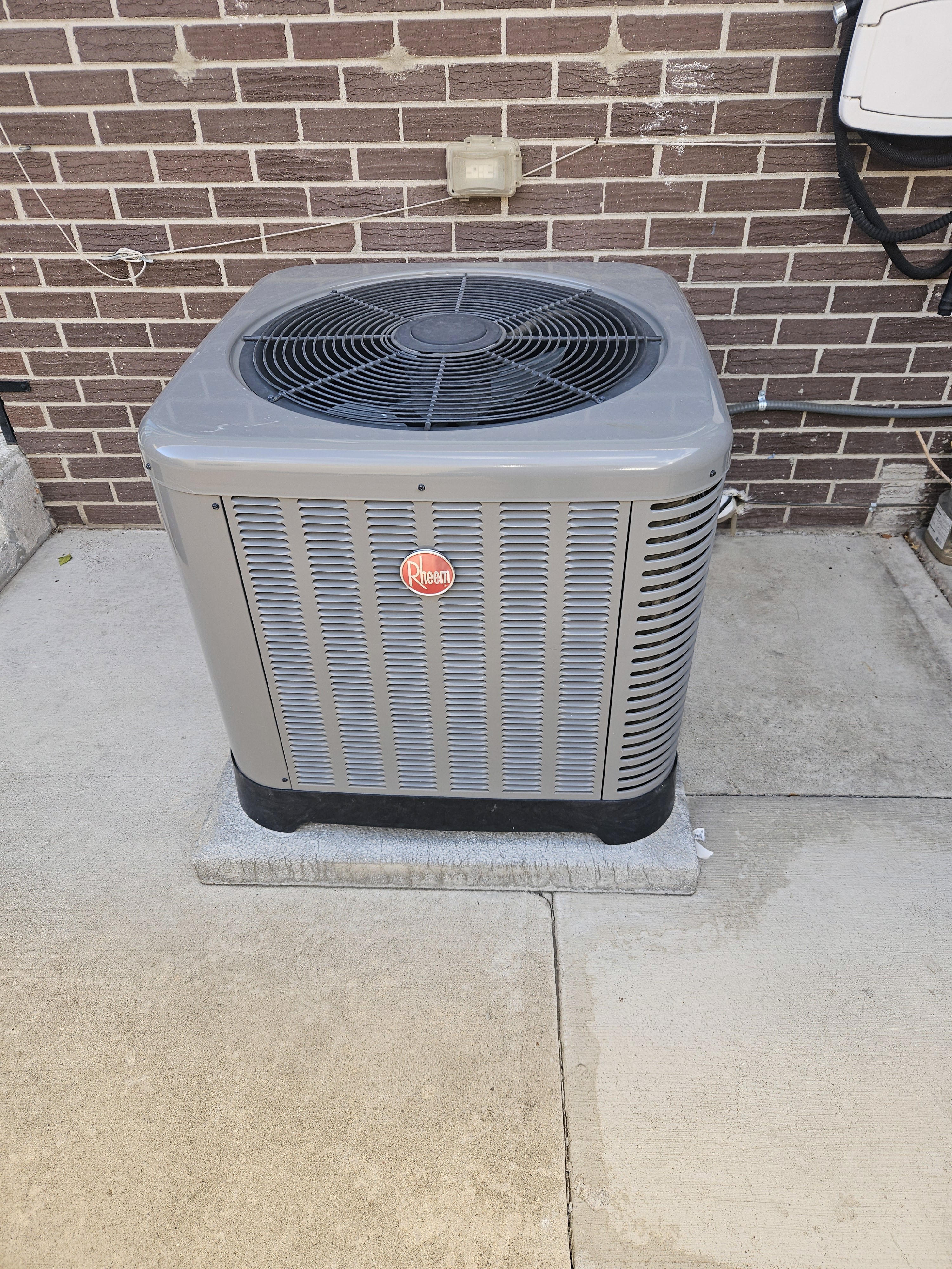 This is a Rheem outdoor air conditioner condenser unit. 