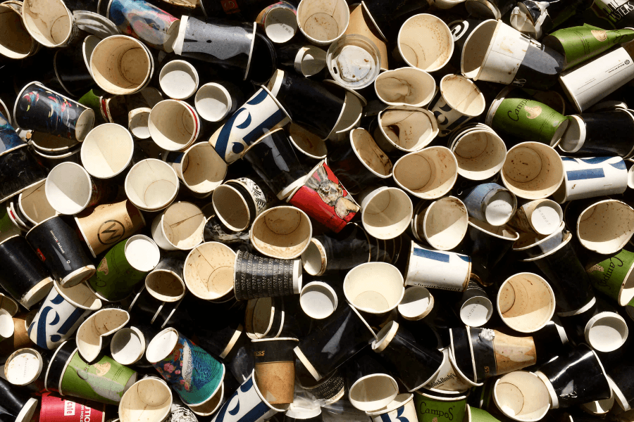 Pile of discarded single-use coffee cups, illustrating Australia’s coffee waste problem and the need for circular solutions.