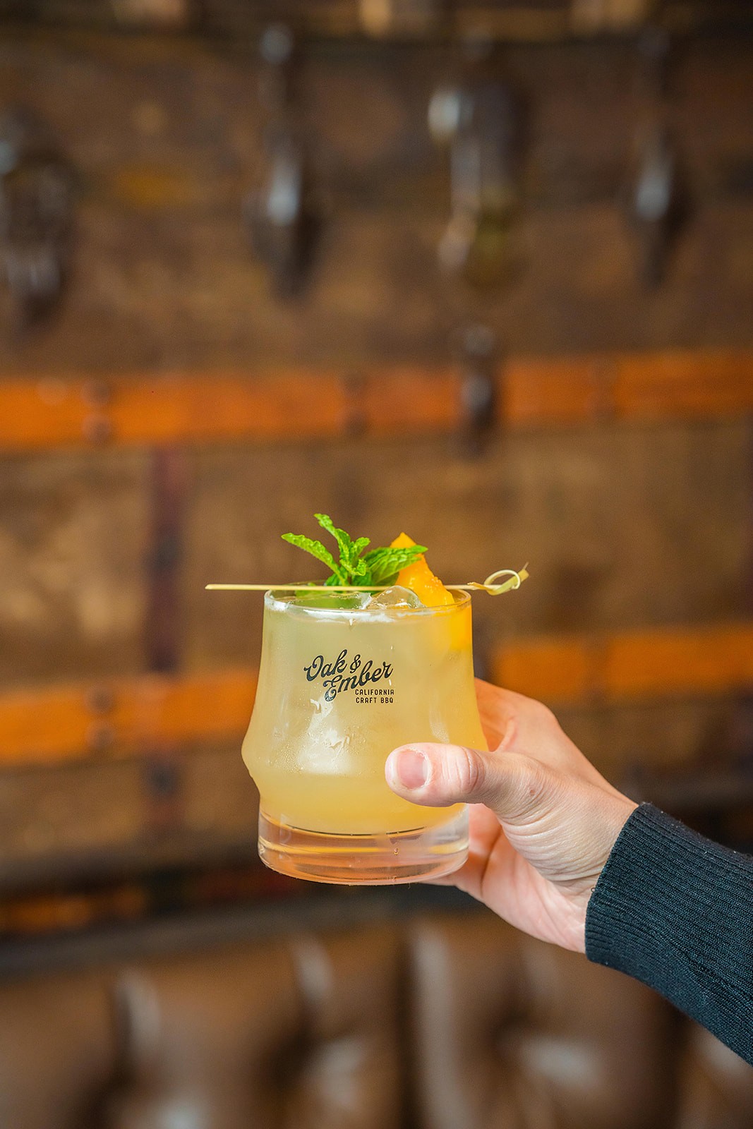Oak and Ember yellow cocktail with citrus garnish