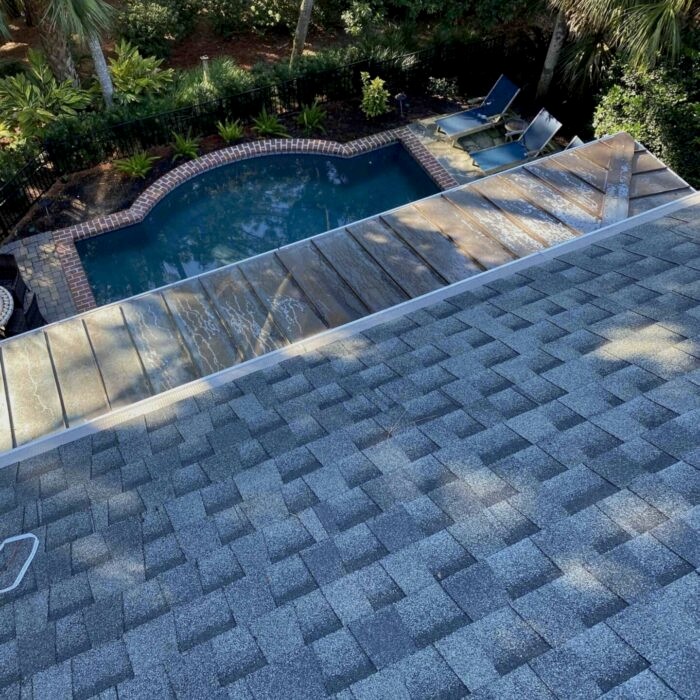 Before and after—downspout flushing showing improved water drainage after professional cleaning.