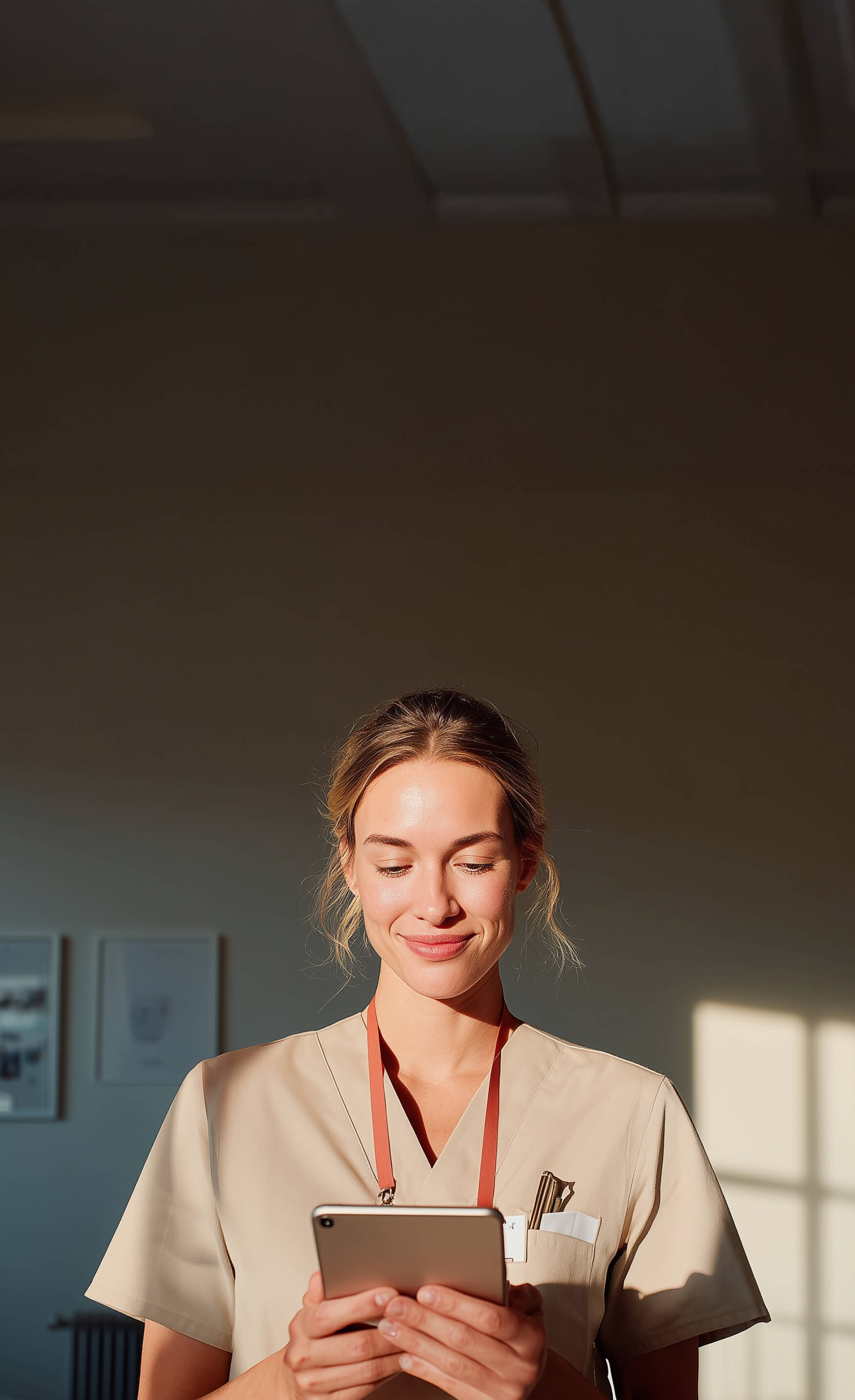 A female nurse looking at her tablet.