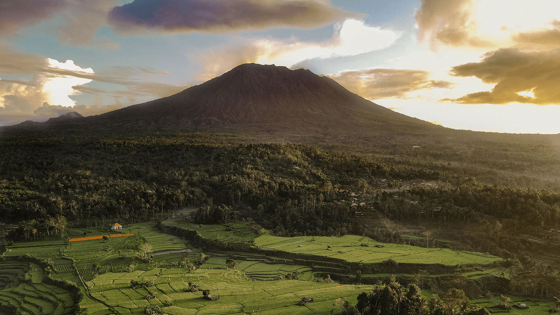 Aerial drone view of Mount Batur and Bali rice fields - the cinematic locations WeDo Creative uses for luxury hotel and resort campaign production across the island