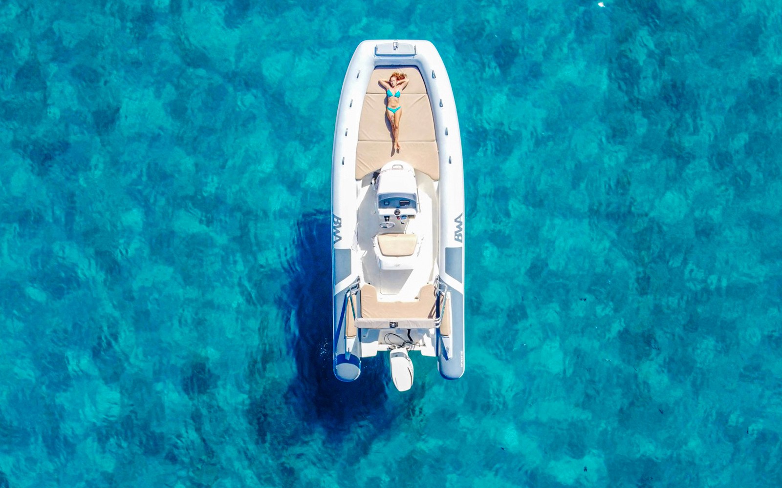 Boat on clear blue waters during Gulf of Cagliari tour.