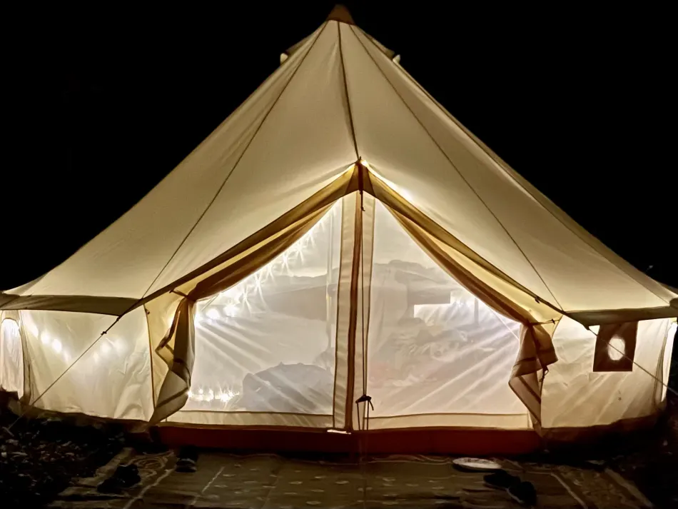 A photo of a tent at night