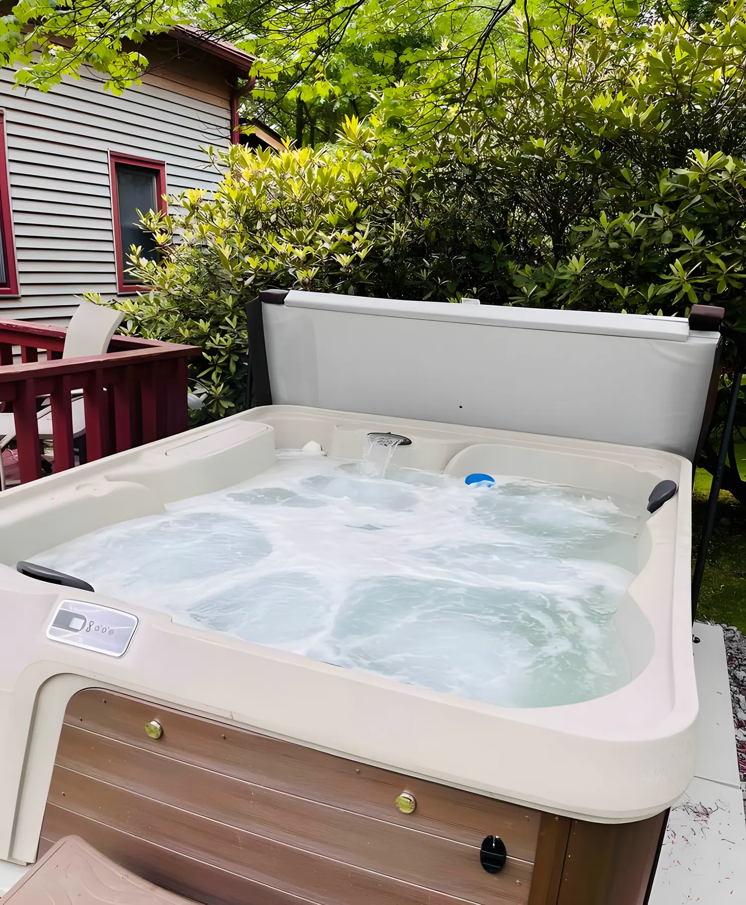 Outdoor hot tub with cover lifted beside the house at DeerPath Crossing, Lake Harmony, PA