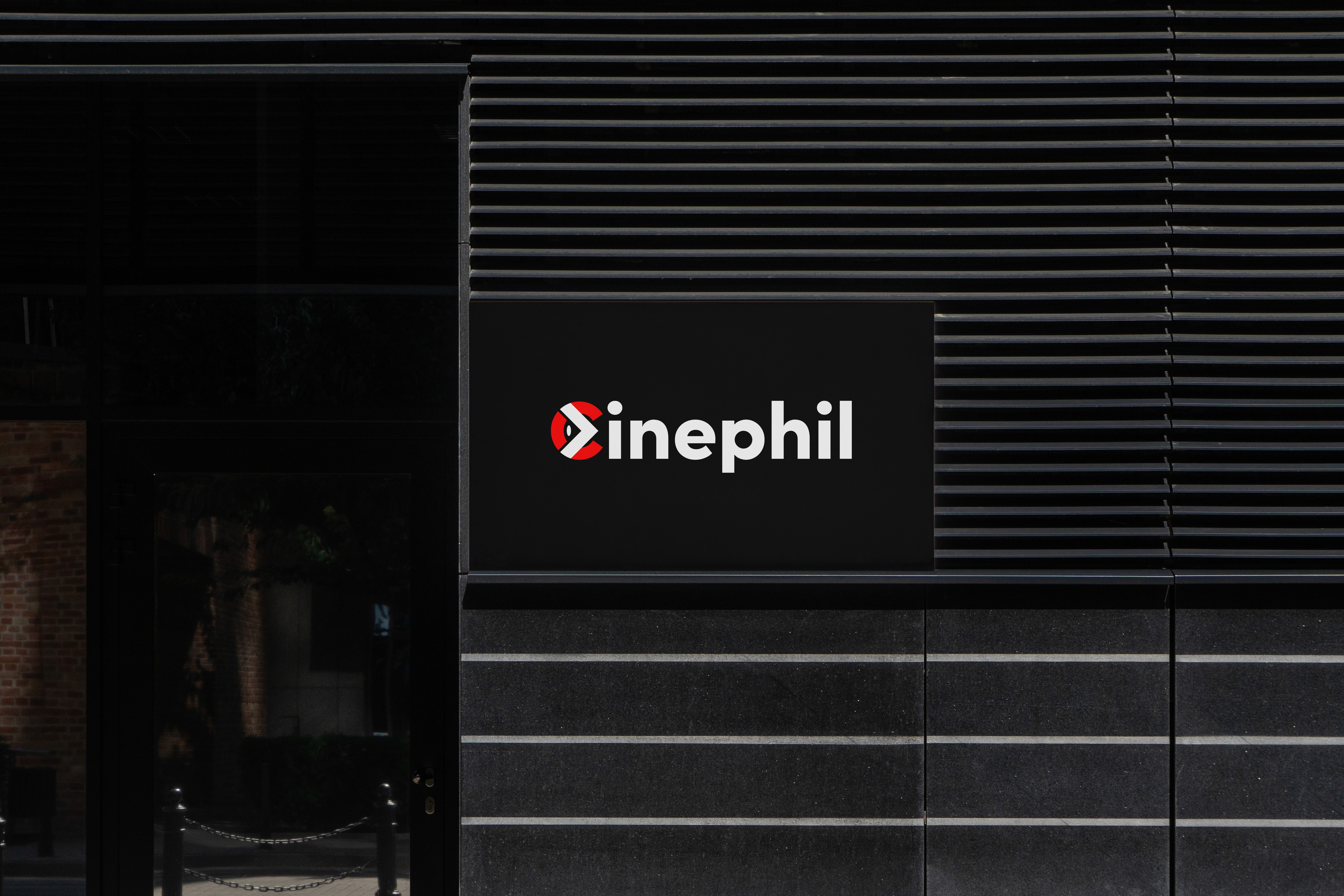 Modern home office setup with a monitor, ergonomic chair, keyboard, and indoor plants near a window with blinds.