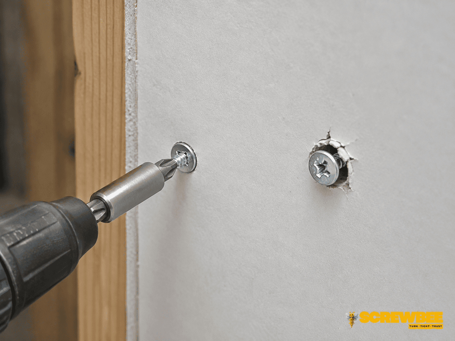 Drywall screw being installed into gypsum board and wood framing with correct driving depth
