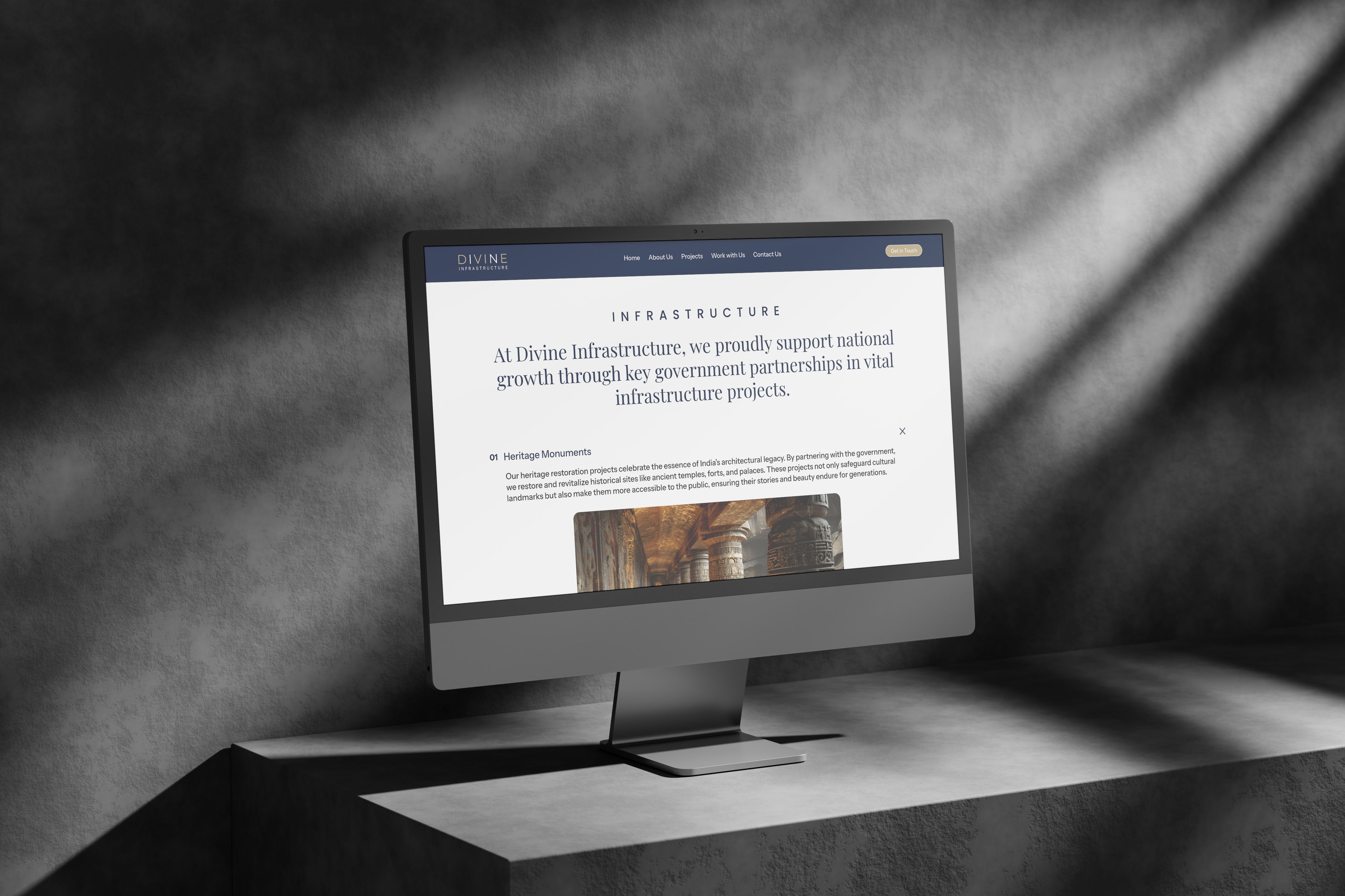 A sleek desktop computer displays the "Securing Infrastructure" webpage.  The site highlights partnerships and infrastructure projects.