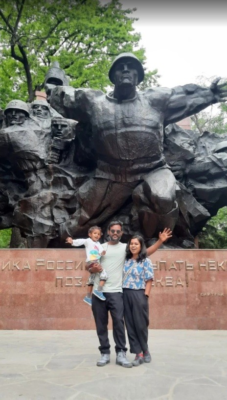 woman in black long sleeve shirt wearing white hat standing on green grass field during daytime