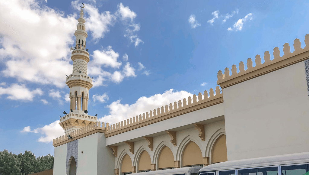 The exterior of a mosque located in Dubai Investment Park, featuring intricate designs and a serene environment.