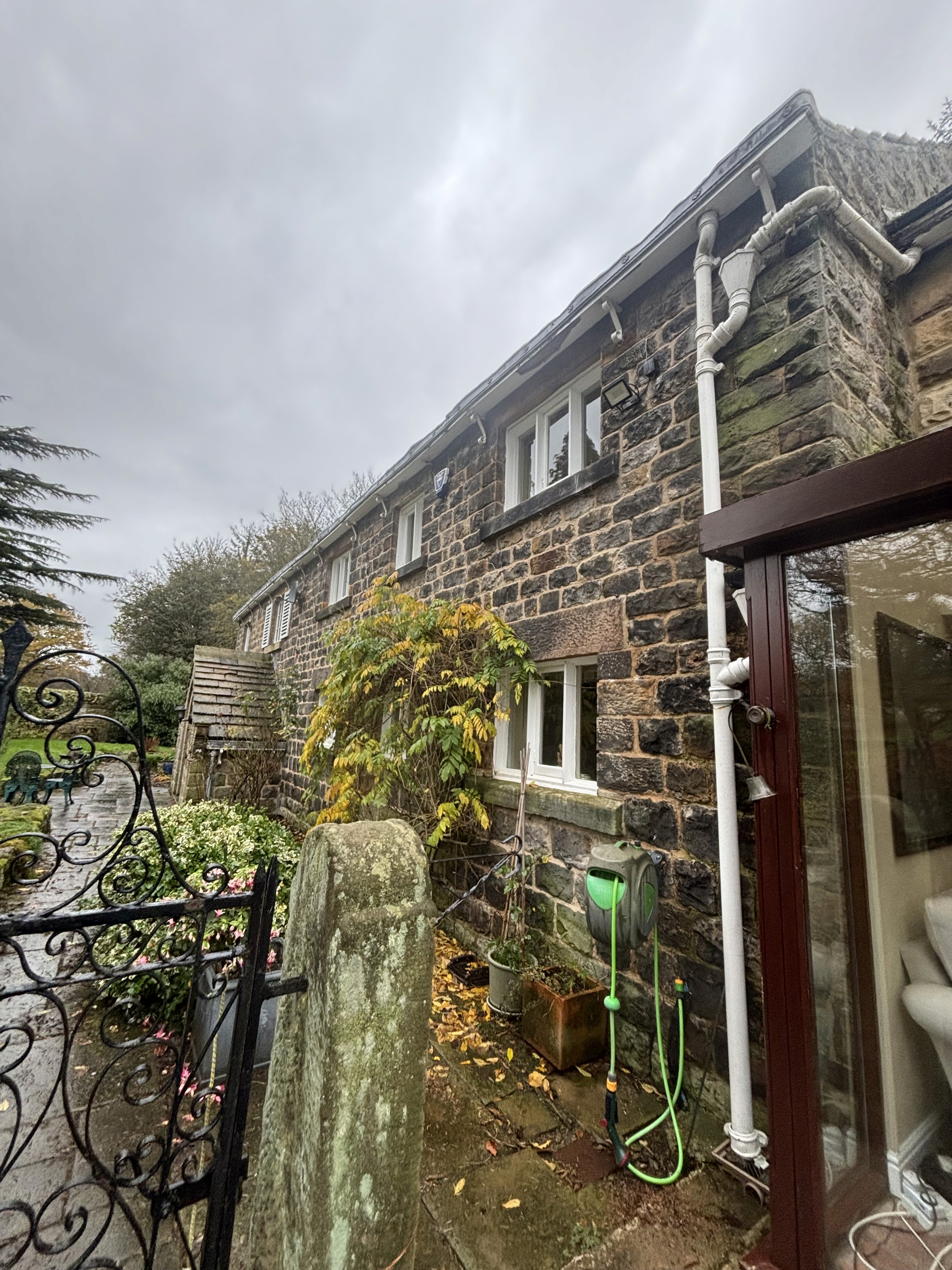 Gutter vacuum equipment removing blockage from residential downpipe