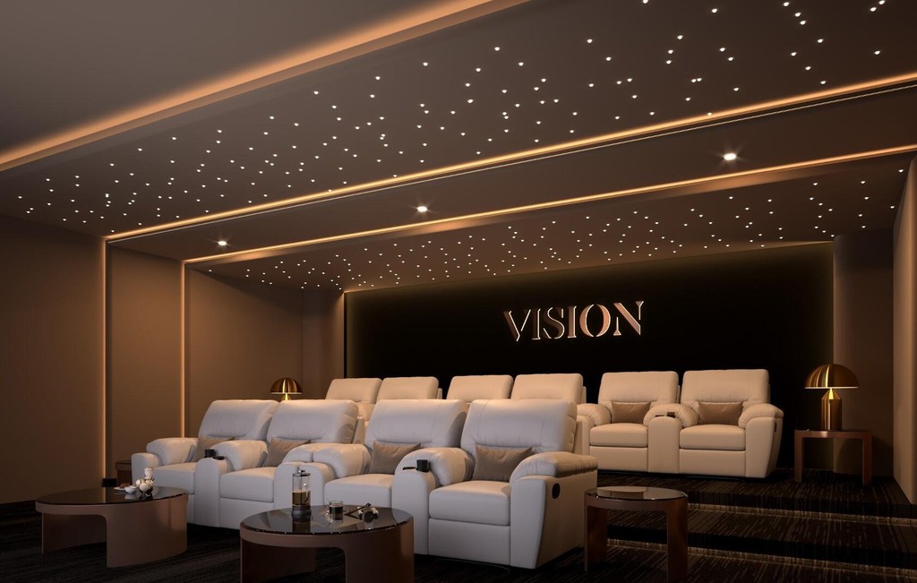 Home theater featuring white chairs and a large screen, branded as Vista by Vision.