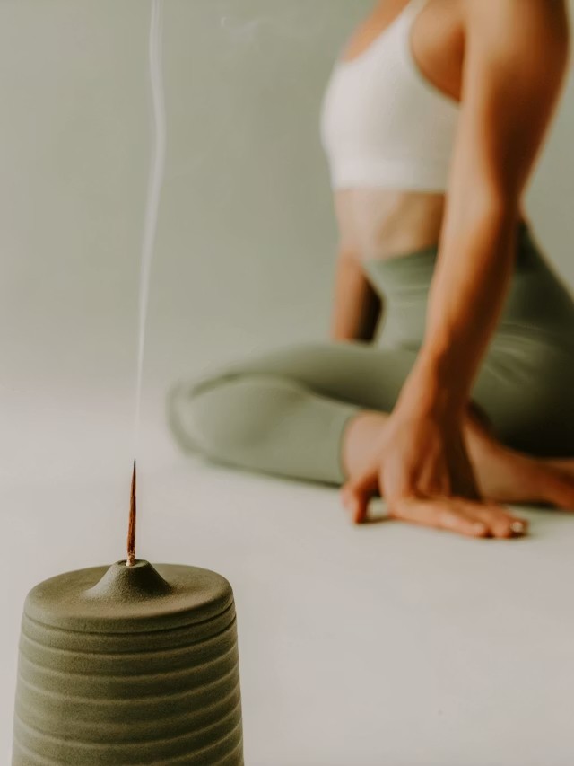 Woman sitting in a calm, relaxed pose representing rest and nervous system support