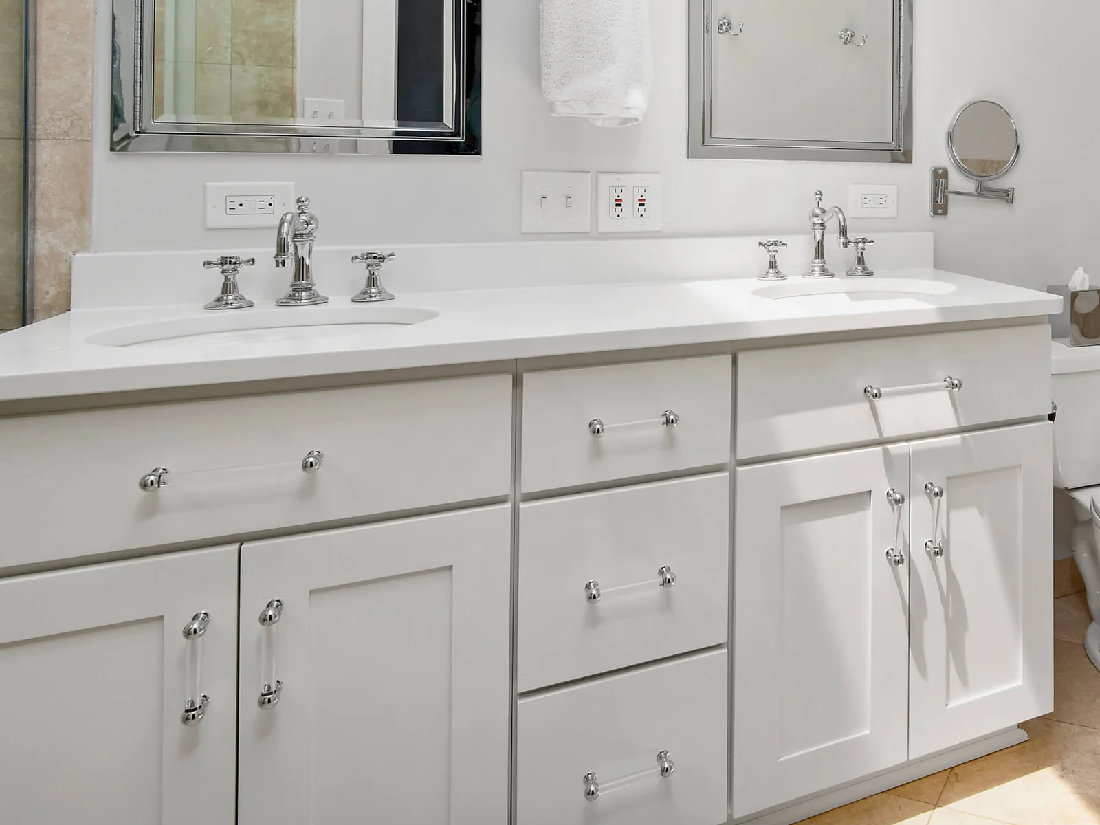 Close view of slab drawer fronts on a white bathroom vanity