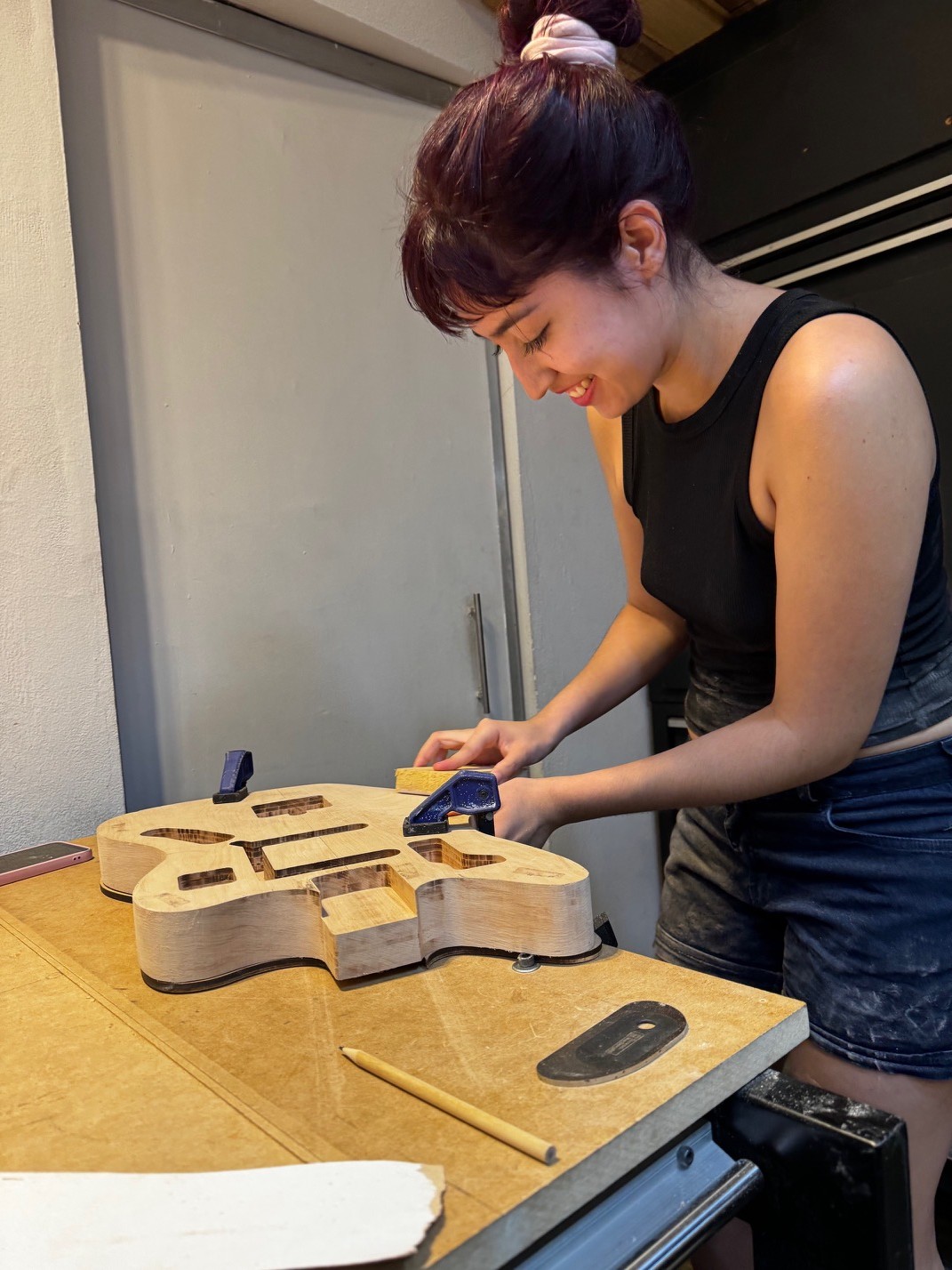 Luthier working on a guitar body in the Sentous workshop