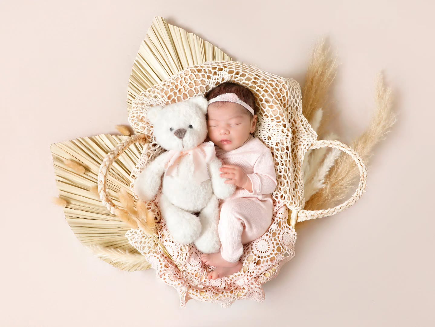 Newborn photoshoot in Dubai with a baby sleeping in a rustic bohemian theme, featured at A professional Mahvin Photography session