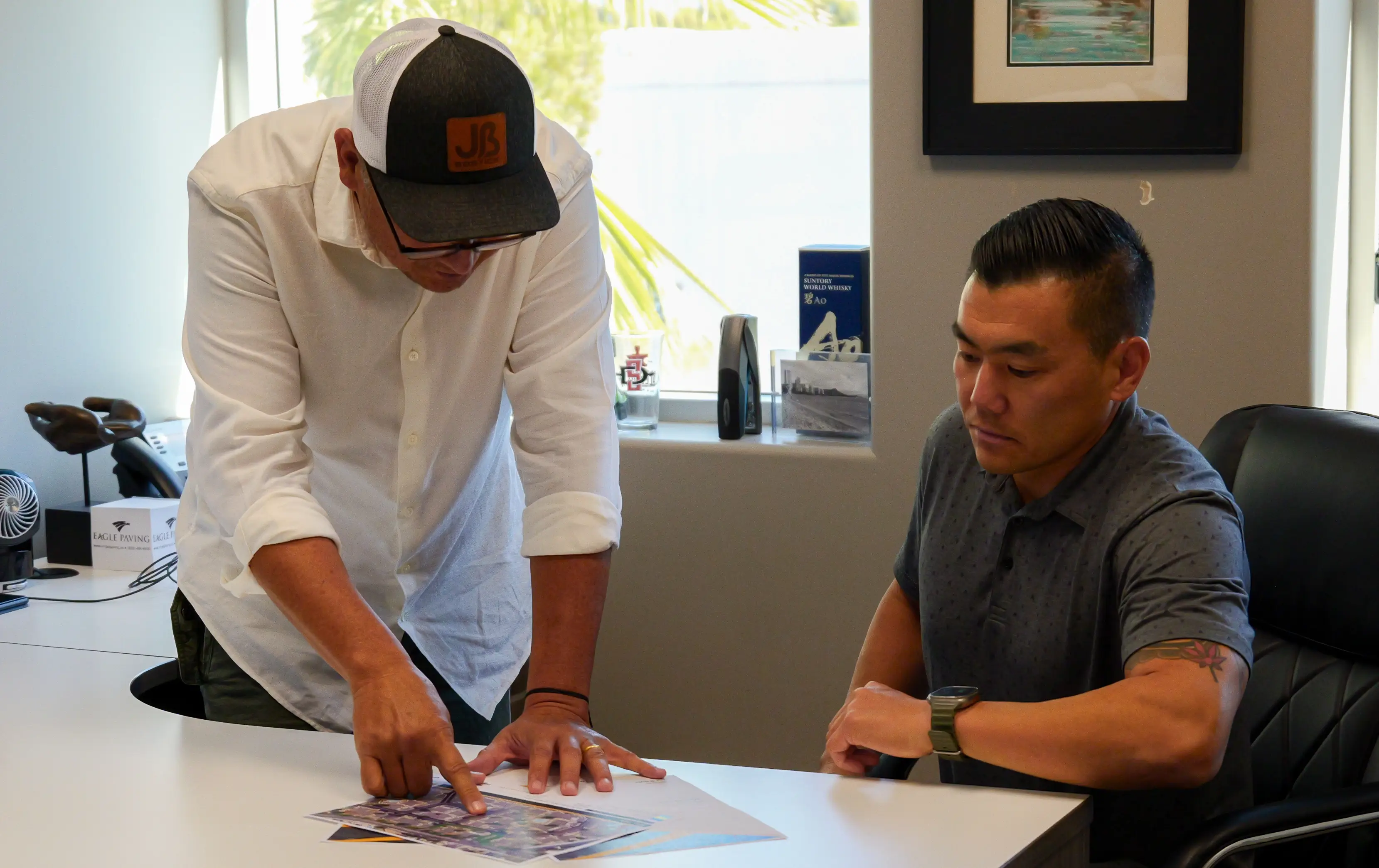 Office workers discussing a project looking at plans