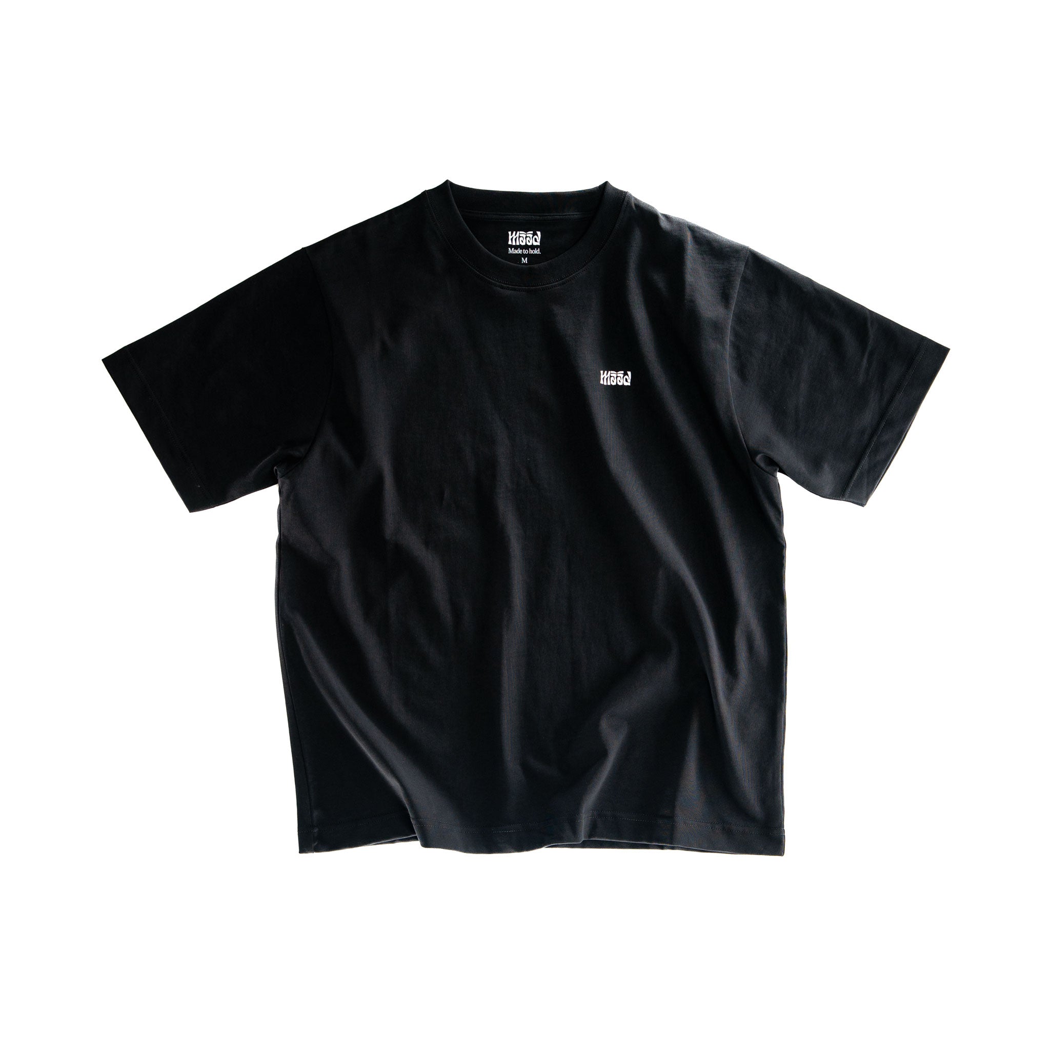 Black t-shirt with a small white logo on a white background
