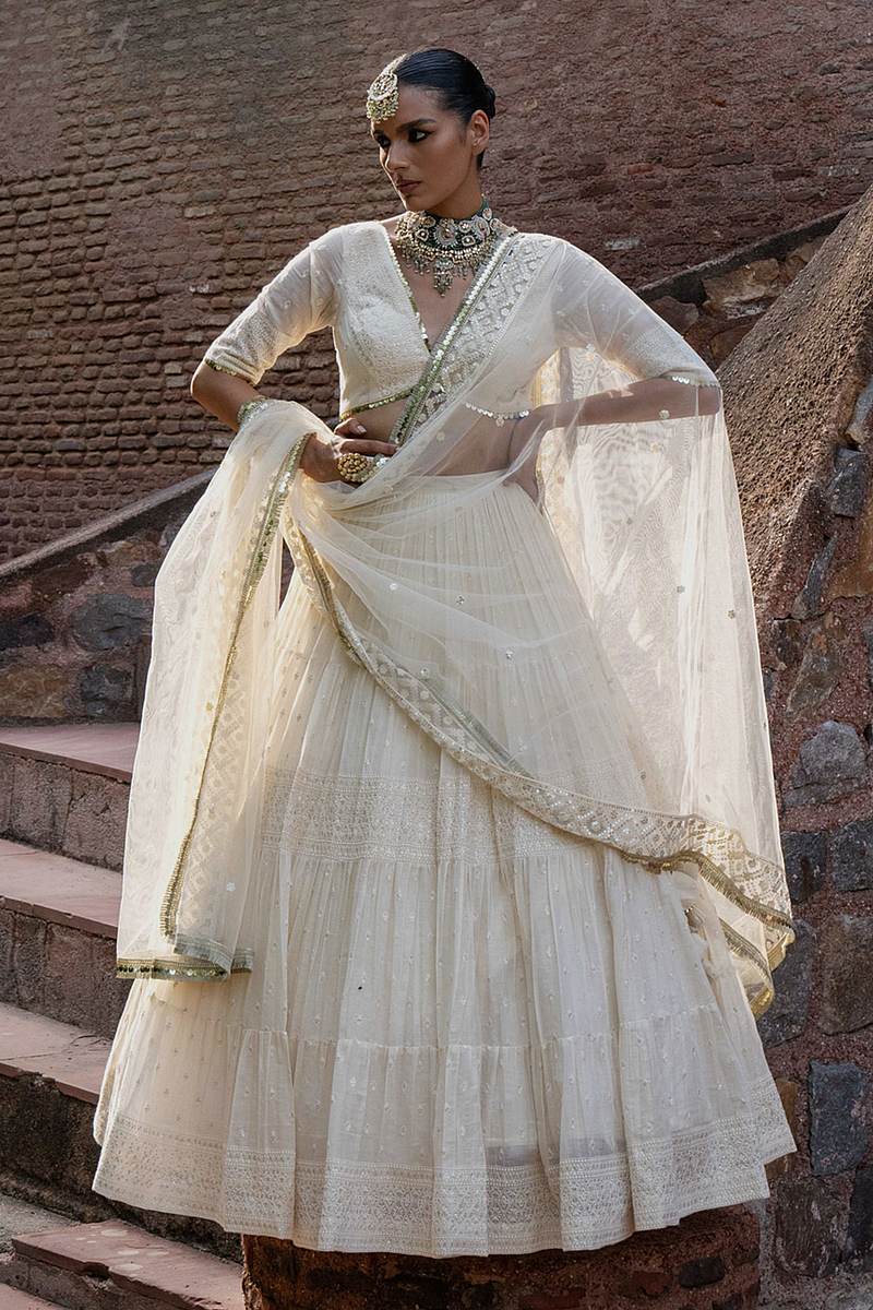 Ivory and antique gold lehenga with a wide gold border by Preevin