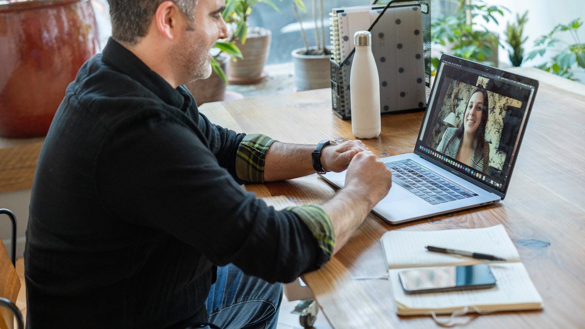 A workshop participant speaking to a colleague on Zoom during a design thinking workshop  