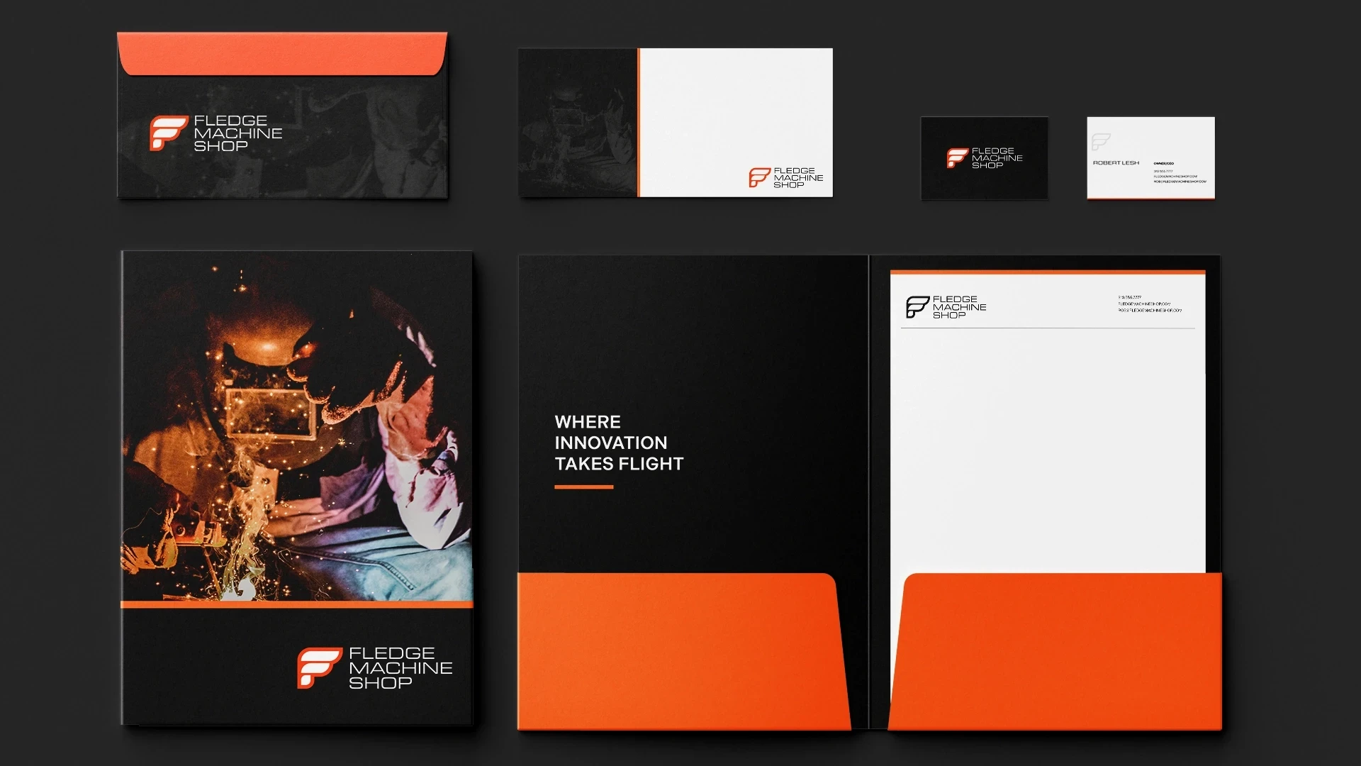 Fledge Machine Shop stationery set with black and orange folders, letterhead, and business cards