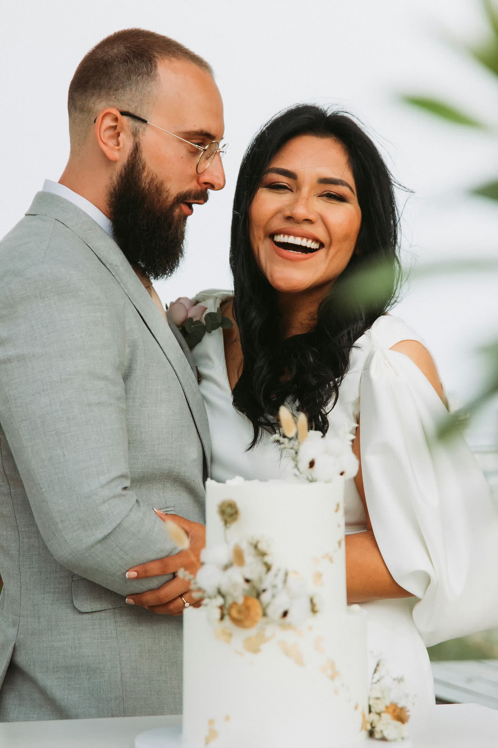 A joyful couple stands together.