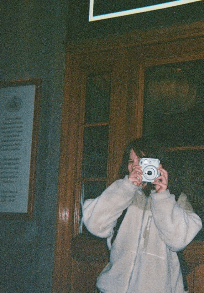 Woman taking a polaroid photo