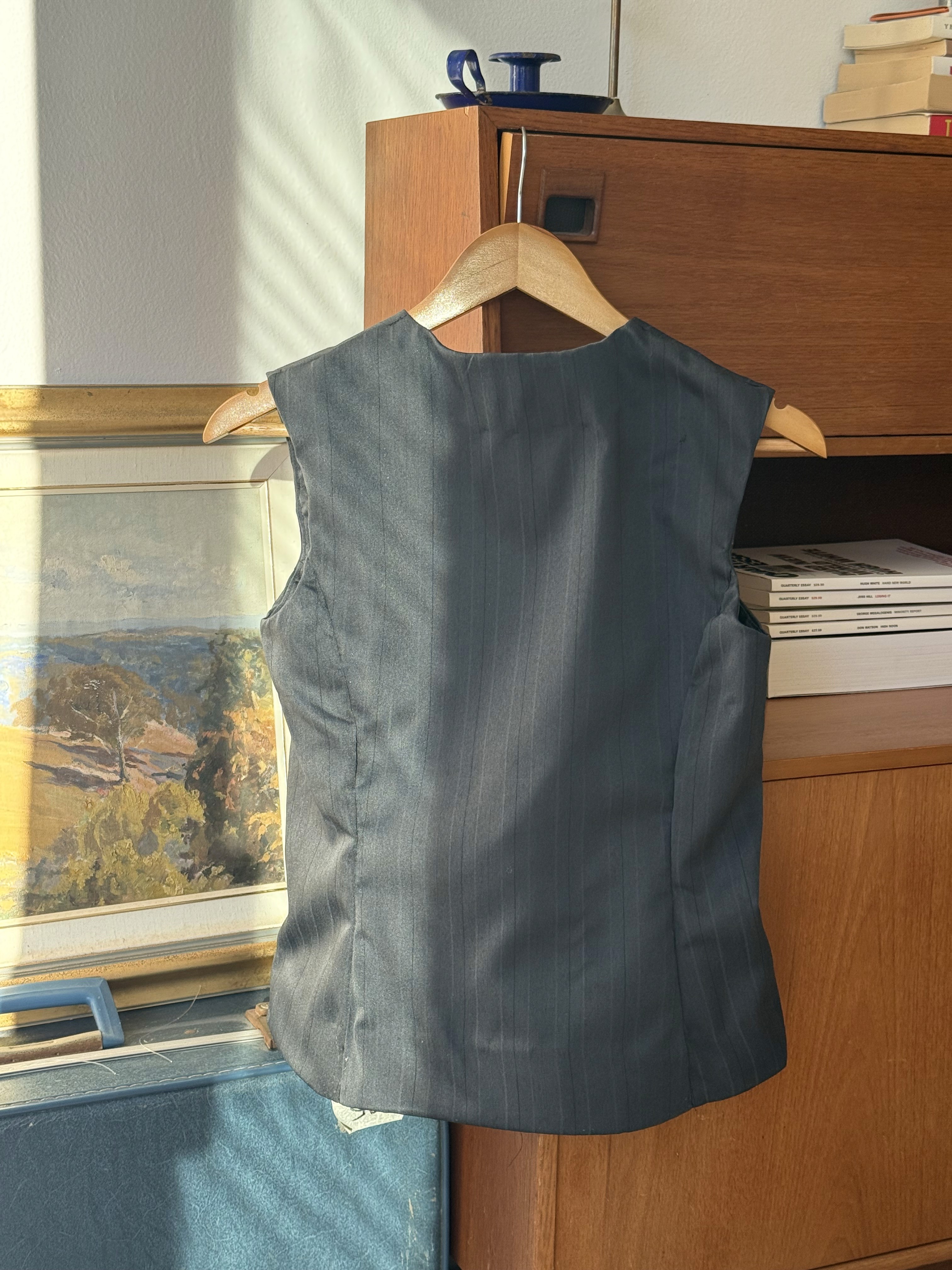 Back of black pin-stripe sleevless vest 