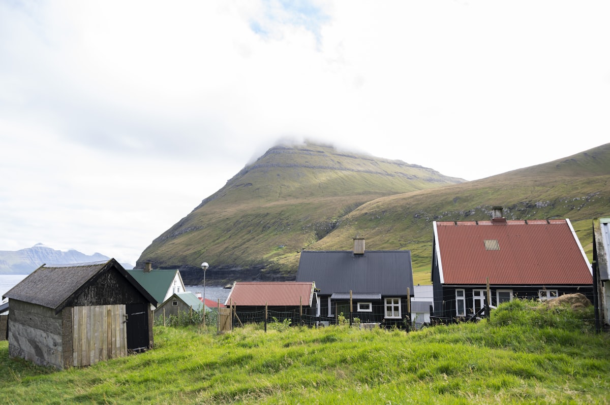 Colorful Nordic village houses against a misty green mountain in the Faroe Islands