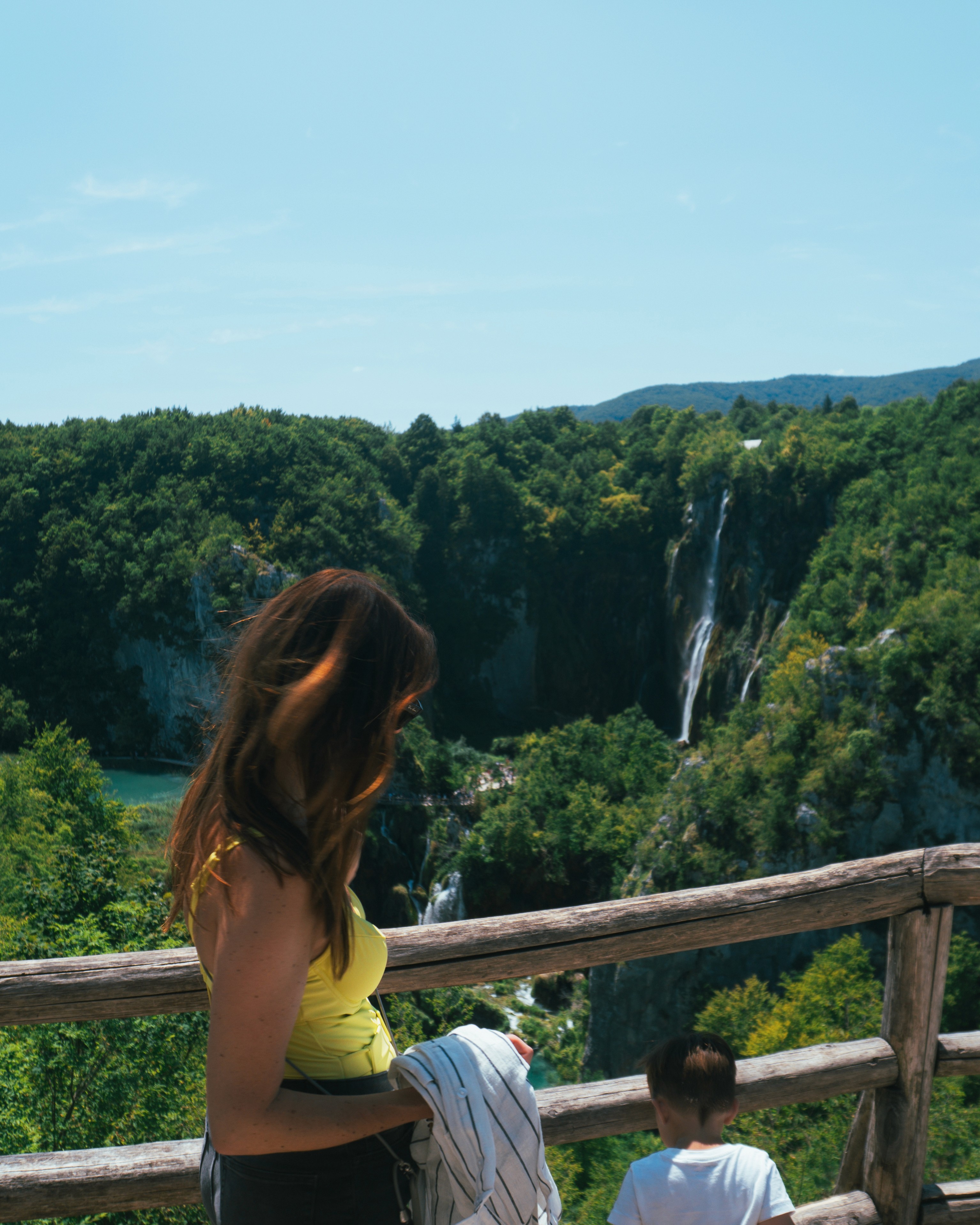 Portrait of a laughing person with curly hair wearing a white shirt