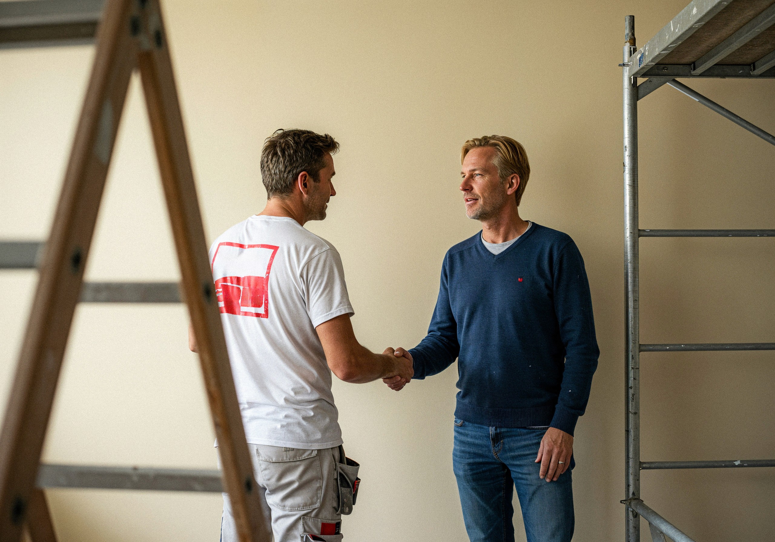 Barista handing a coffee to customers in a cosy cafe