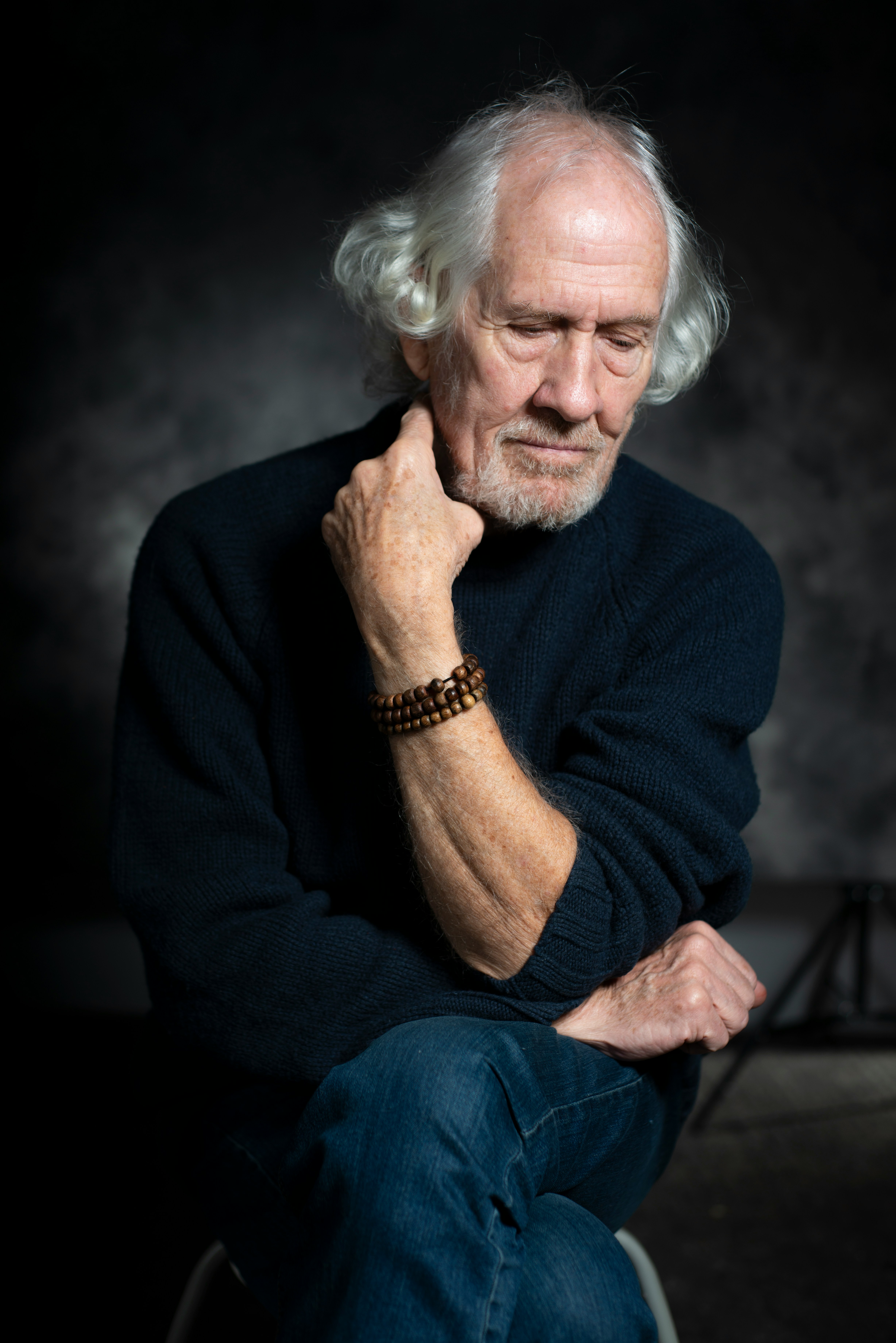 man in black long sleeve shirt sitting on chair